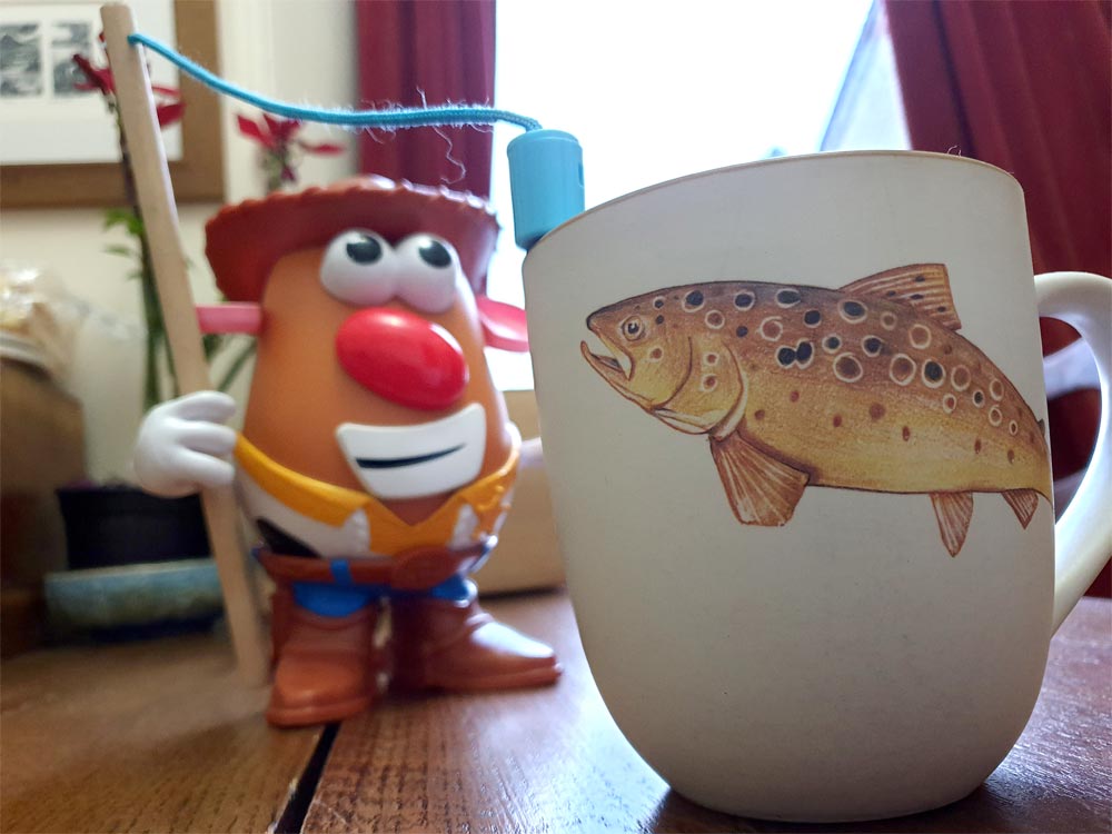 Mr Potato Head fishes for an Angus Grant Art mug