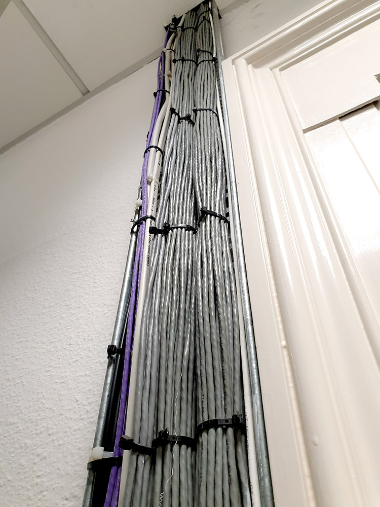 Bundles of wires running up into ceiling